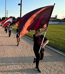 A Mark Keppel Color Guard performer rehearsing with a flag